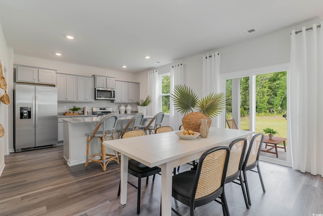 dining room with wood finished floors and recessed lighting