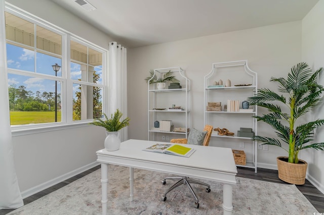 office space with wood finished floors and baseboards