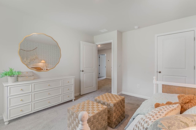 bedroom with light colored carpet and baseboards