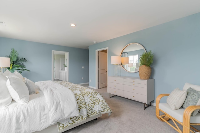 bedroom featuring baseboards, light carpet, ensuite bath, and recessed lighting