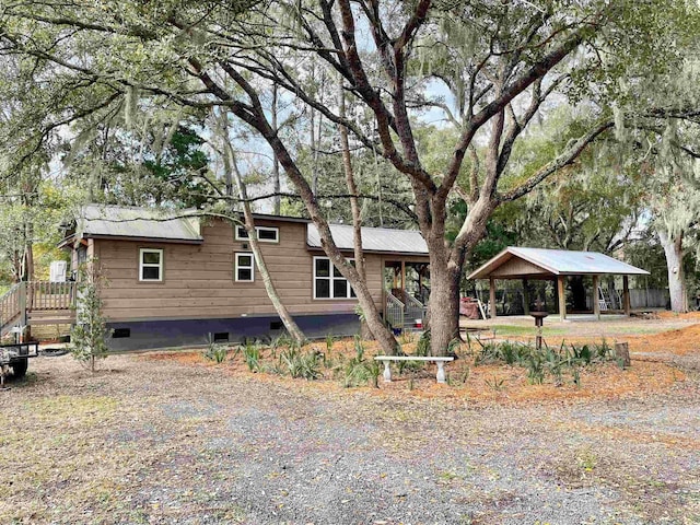 back of house with crawl space and a gazebo