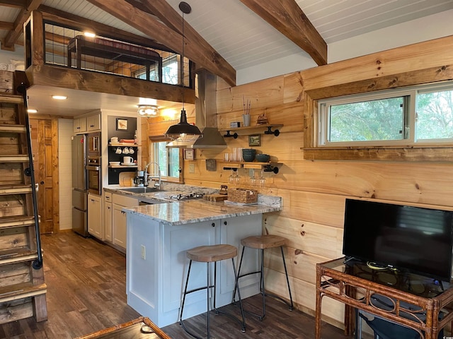 kitchen with wooden walls, beam ceiling, a peninsula, dark wood-style floors, and open shelves