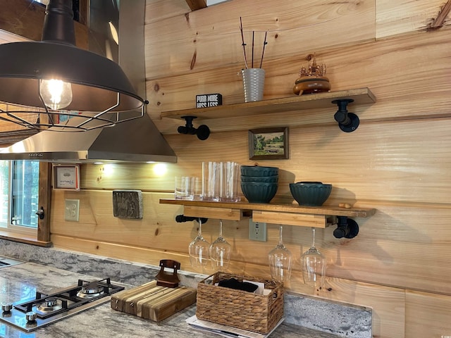 kitchen with stainless steel gas stovetop and island range hood