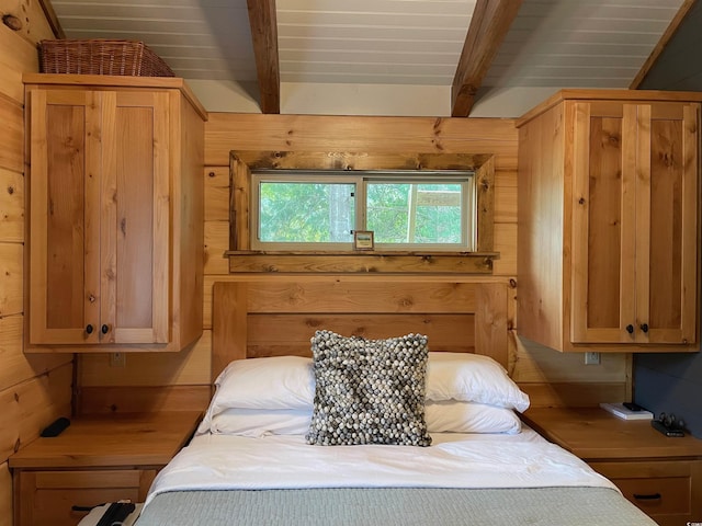 bedroom featuring beamed ceiling, wooden walls, and wooden ceiling