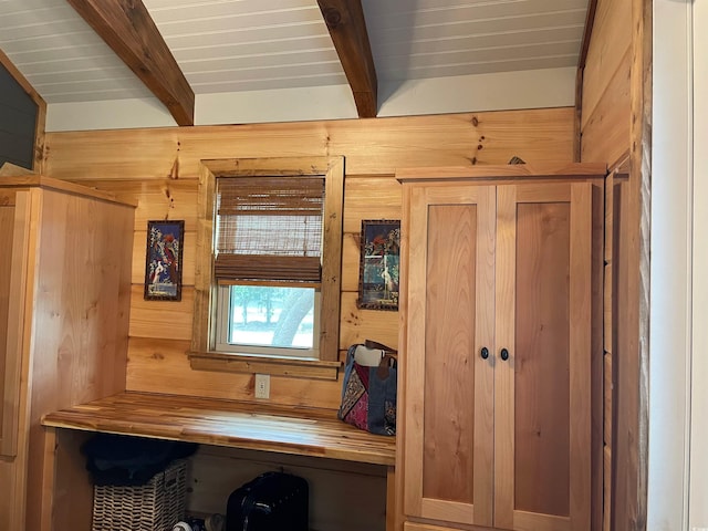 office with beam ceiling, wood walls, and wooden ceiling