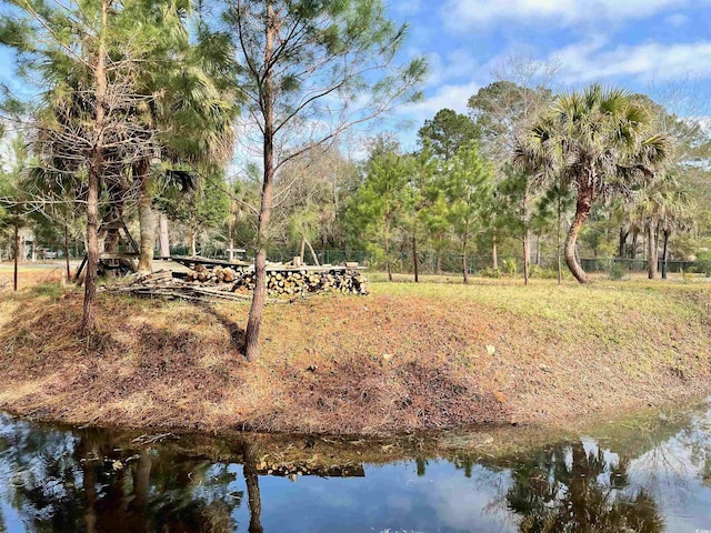 view of community featuring fence and a water view