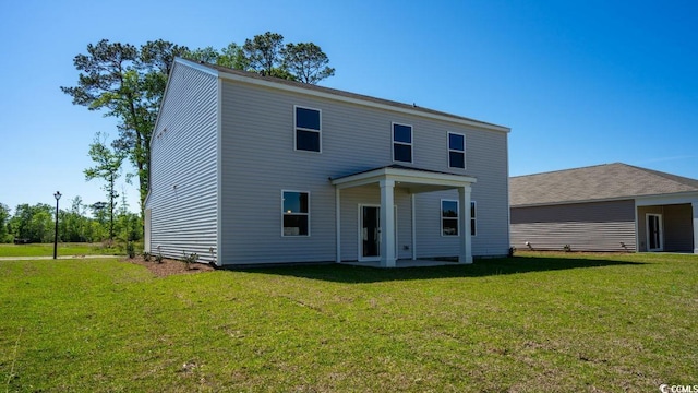 4484 E Coast Ln, Shallotte, NC 28470 - rear view of property with a yard