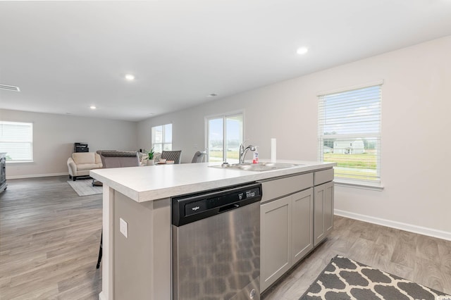 4484 E Coast Ln, Shallotte, NC 28470 - kitchen with dishwasher, a sink, light countertops, a kitchen island with sink, and light wood-style flooring