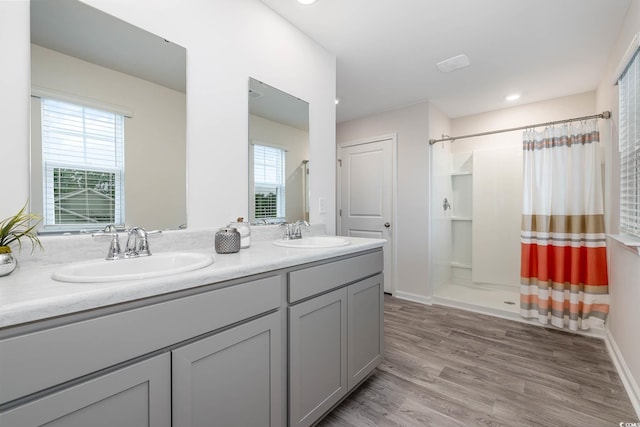 4484 E Coast Ln, Shallotte, NC 28470 - full bath with a shower with curtain, double vanity, and wood finished floors