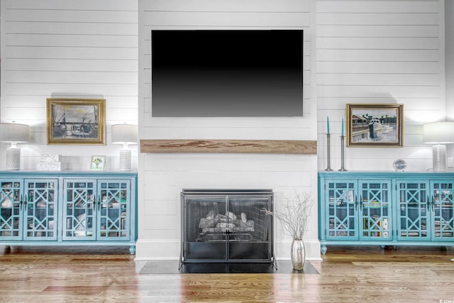 2425 S Bay St, Georgetown, SC 29440 - detailed view of wood finished floors, a fireplace with flush hearth, and wood walls