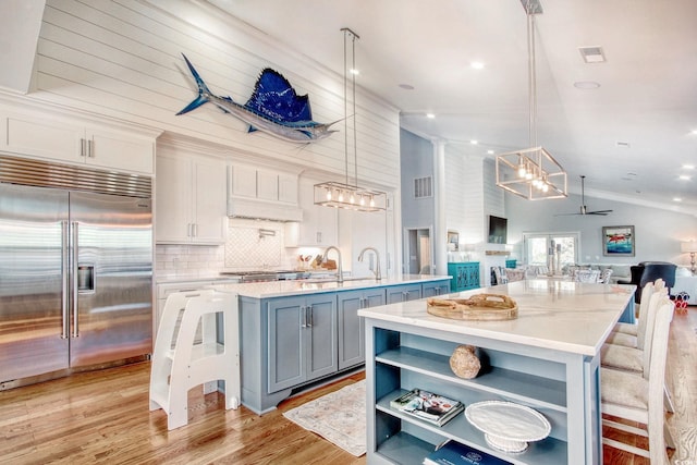 2425 S Bay St, Georgetown, SC 29440 - kitchen with appliances with stainless steel finishes, a spacious island, lofted ceiling, open floor plan, and open shelves