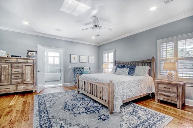 2425 S Bay St, Georgetown, SC 29440 - bedroom featuring multiple windows, crown molding, light wood finished floors, baseboards, and ensuite bathroom