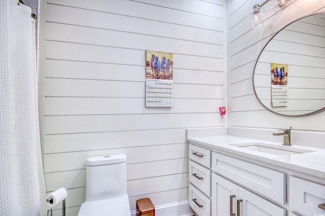 2425 S Bay St, Georgetown, SC 29440 - full bathroom with vanity, wooden walls, toilet, and a shower with curtain