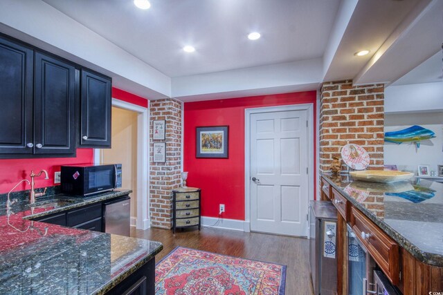 2425 S Bay St, Georgetown, SC 29440 - kitchen with black microwave, a sink, dark wood-style flooring, dark stone countertops, and recessed lighting