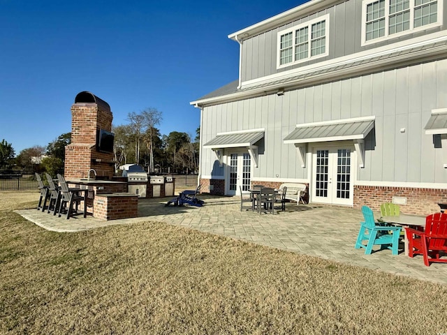 2425 S Bay St, Georgetown, SC 29440 - rear view of property with french doors, a patio area, an outdoor kitchen, and board and batten siding
