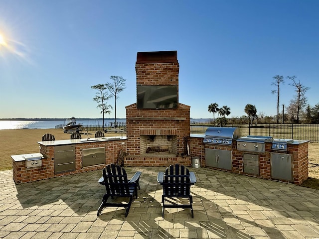 2425 S Bay St, Georgetown, SC 29440 - view of patio / terrace featuring an outdoor brick fireplace and a water view