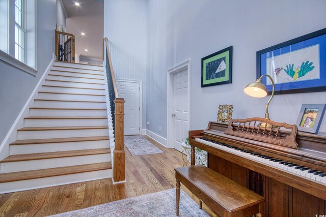 2425 S Bay St, Georgetown, SC 29440 - stairs with wood finished floors, baseboards, and a towering ceiling