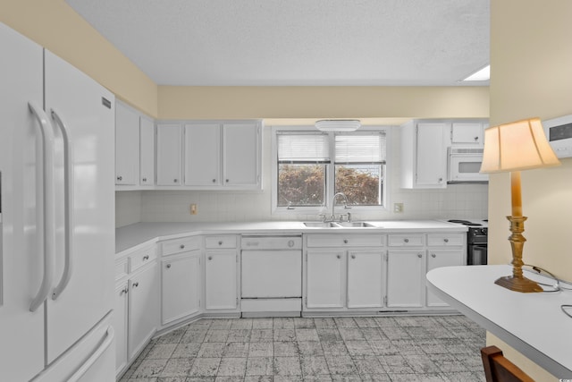 5616 N Kings Hwy, Myrtle Beach, SC 29577 - kitchen featuring white appliances, a sink, light countertops, decorative backsplash, and light flooring