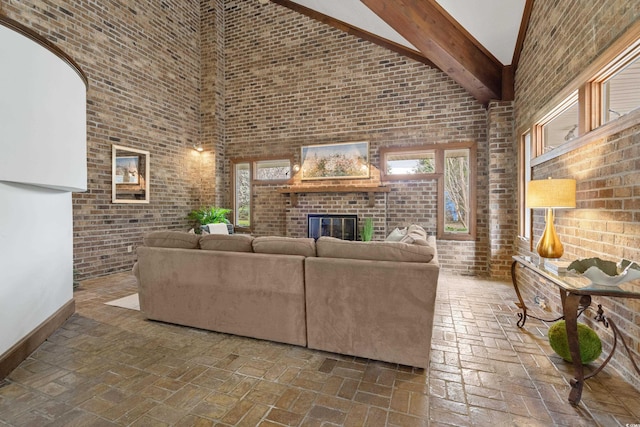5616 N Kings Hwy, Myrtle Beach, SC 29577 - living area featuring high vaulted ceiling, brick wall, a fireplace, brick floors, and baseboards