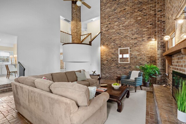 5616 N Kings Hwy, Myrtle Beach, SC 29577 - living area with a towering ceiling, brick floors, brick wall, a ceiling fan, and a fireplace