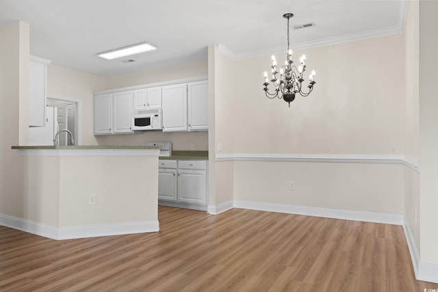 2081 Silvercrest Dr Unit G, Myrtle Beach, SC 29579 - kitchen featuring white appliances, light wood-type flooring, white cabinetry, baseboards, and crown molding