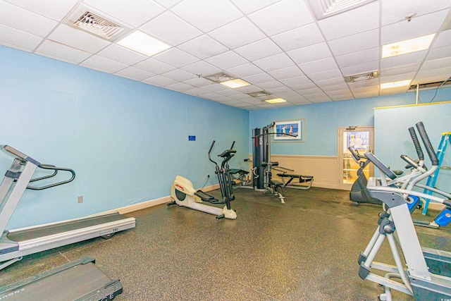 exercise room with a paneled ceiling