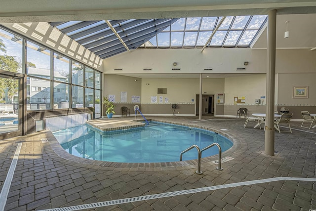 indoor community pool with a patio and glass enclosure