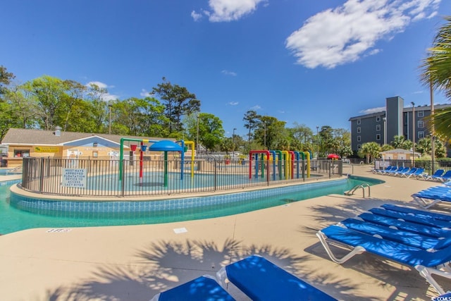community pool with a water play area and fence