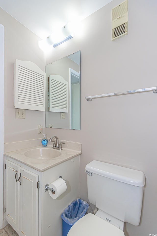 bathroom with toilet and vanity