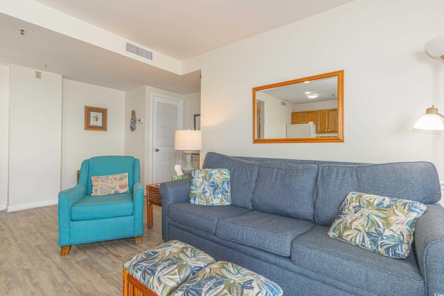living room with wood finished floors and baseboards