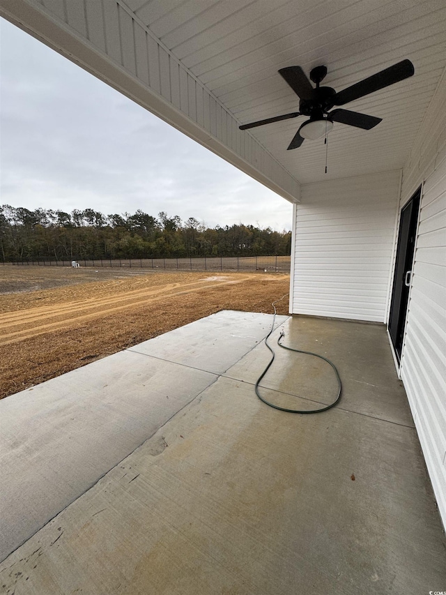 view of patio with a ceiling fan and fence