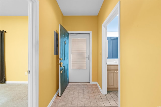 hallway with baseboards and electric panel