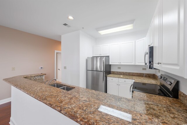 1025 World Tour Blvd Unit 101A, Myrtle Beach, SC 29579 - kitchen featuring stainless steel appliances, a sink, stone countertops, white cabinetry, and dark wood-style floors
