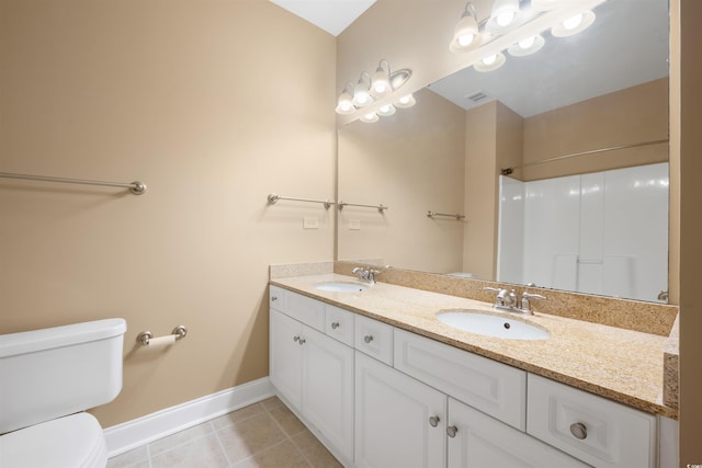 1025 World Tour Blvd Unit 101A, Myrtle Beach, SC 29579 - bathroom featuring toilet, baseboards, tile patterned flooring, double vanity, and a shower