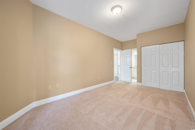 1025 World Tour Blvd Unit 101A, Myrtle Beach, SC 29579 - unfurnished bedroom with light colored carpet, baseboards, and a closet