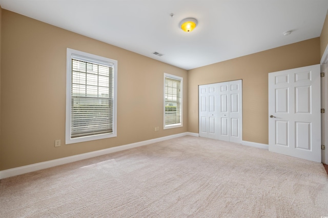 1025 World Tour Blvd Unit 101A, Myrtle Beach, SC 29579 - unfurnished bedroom with light carpet, a closet, and baseboards