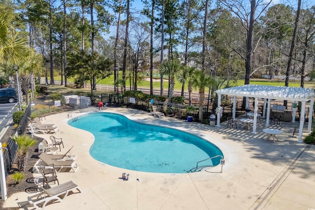 1025 World Tour Blvd Unit 101A, Myrtle Beach, SC 29579 - community pool with a pergola, a patio area, view of wooded area, and fence