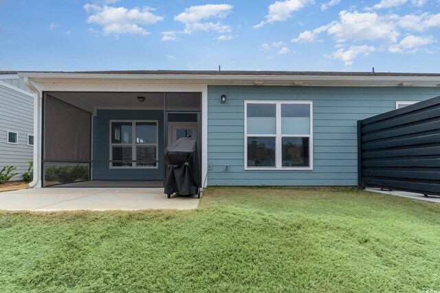 5834 Cremona Dr, Myrtle Beach, SC 29577 - back of property with a patio area, a lawn, and a sunroom