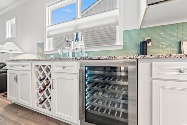 5834 Cremona Dr, Myrtle Beach, SC 29577 - indoor bar with beverage cooler, decorative backsplash, wood finished floors, and ornamental molding