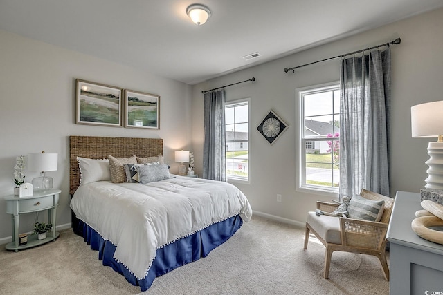 bedroom with visible vents, baseboards, and light colored carpet