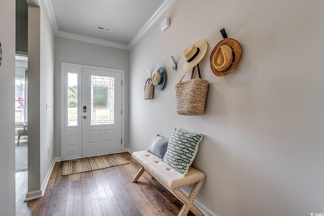 mudroom with wood-type flooring, visible vents, baseboards, and crown molding
