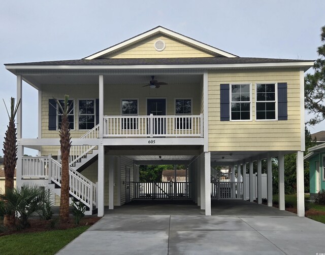 605 15th Ave S, North Myrtle Beach, SC 29582 - coastal inspired home with a carport, a ceiling fan, driveway, stairs, and covered porch