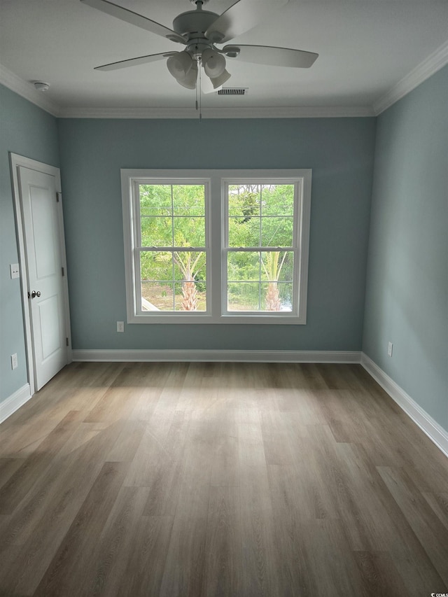 605 15th Ave S, North Myrtle Beach, SC 29582 - empty room with a ceiling fan, wood finished floors, baseboards, ornamental molding, and a smoke detector