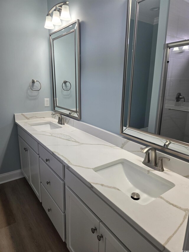 605 15th Ave S, North Myrtle Beach, SC 29582 - bathroom with double vanity, wood finished floors, and an enclosed shower