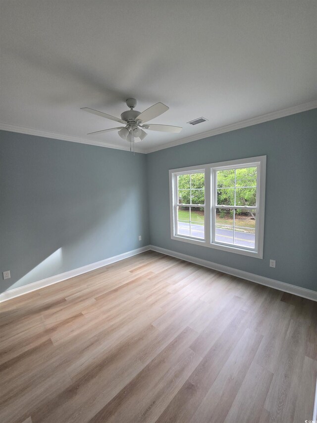605 15th Ave S, North Myrtle Beach, SC 29582 - unfurnished room featuring crown molding, wood finished floors, baseboards, and a ceiling fan