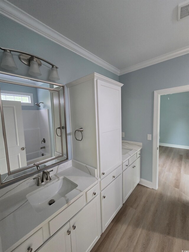 605 15th Ave S, North Myrtle Beach, SC 29582 - full bath featuring vanity, ornamental molding, wood finished floors, shower / tub combination, and baseboards