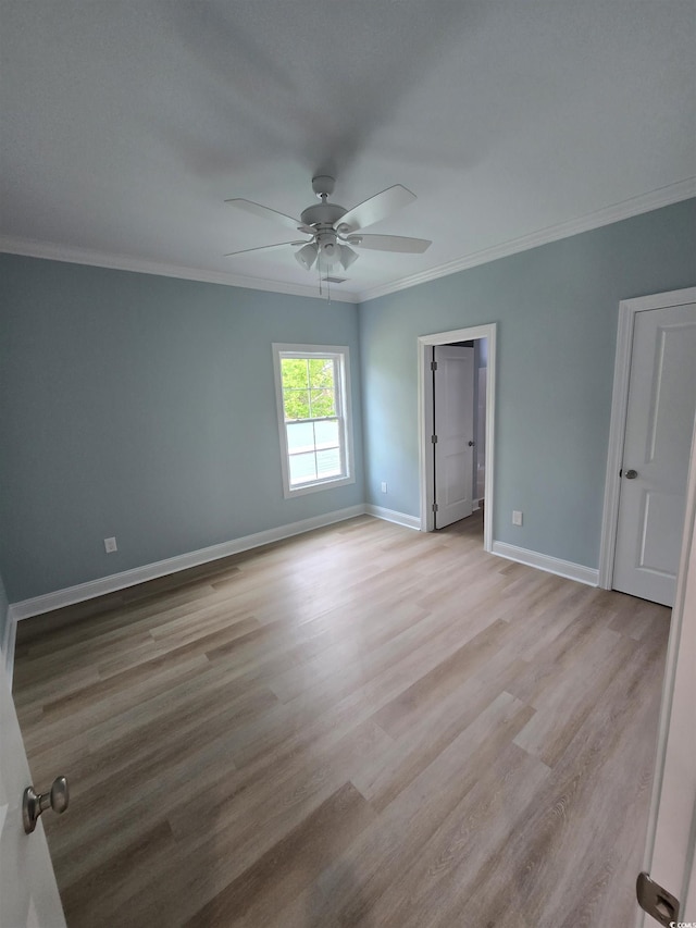605 15th Ave S, North Myrtle Beach, SC 29582 - unfurnished bedroom featuring ornamental molding, light wood-style flooring, baseboards, and ceiling fan