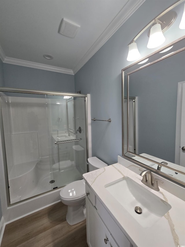 605 15th Ave S, North Myrtle Beach, SC 29582 - bathroom featuring crown molding, toilet, wood finished floors, a stall shower, and vanity