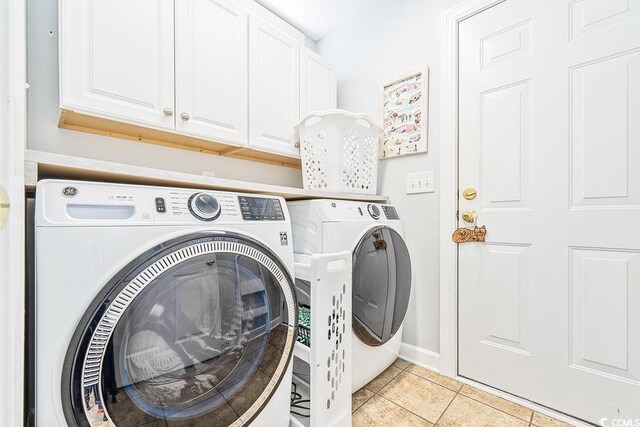 728 Camden Cir, Pawleys Island, SC 29585 - washroom with cabinet space, light tile patterned floors, washer and dryer, and baseboards