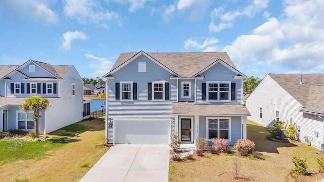3304 Candytuft Dr, Conway, SC 29526 - traditional-style house featuring driveway, roof with shingles, an attached garage, and a front lawn